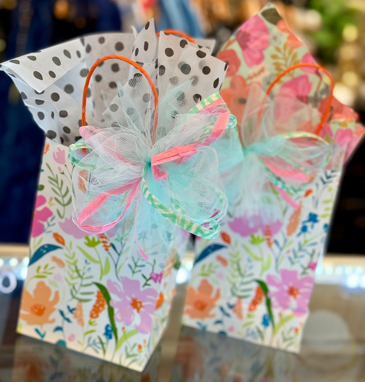 Decorative butterfly gift bags with floral and polka dot patterns.