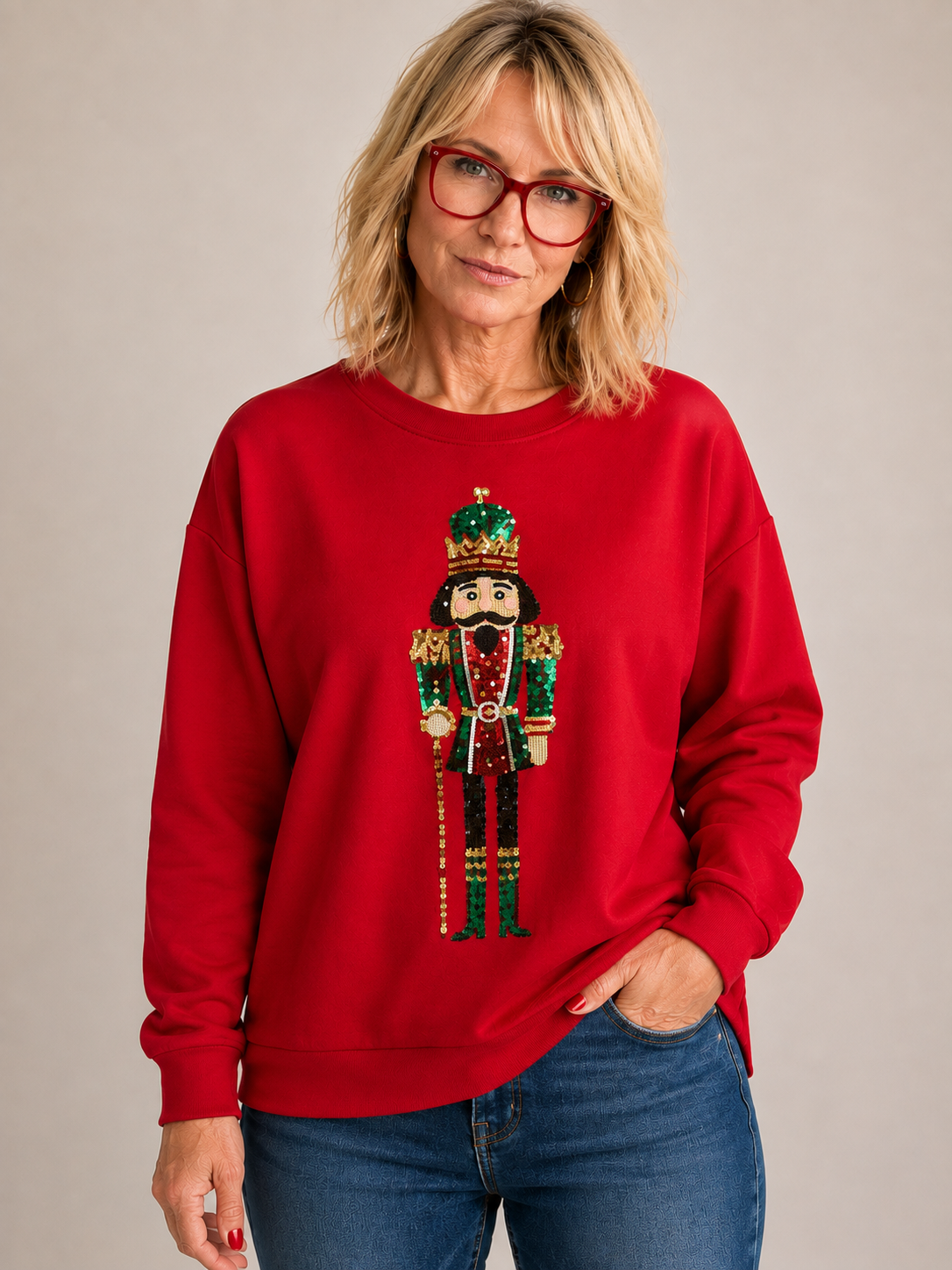 Red sweatshirt with a sequin nutcracker design on the front