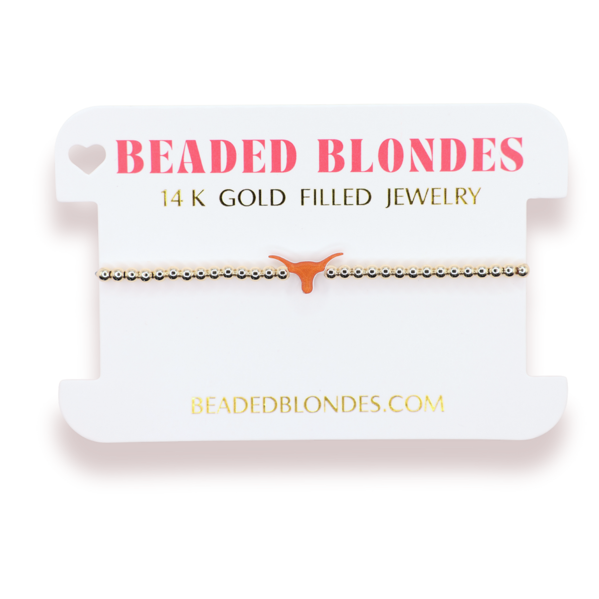 A beaded bracelet with a small orange longhorn-shaped charm, displayed on a white branded card that reads 'BEADED BLONDES' and '14 K GOLD FILLED JEWELRY'.