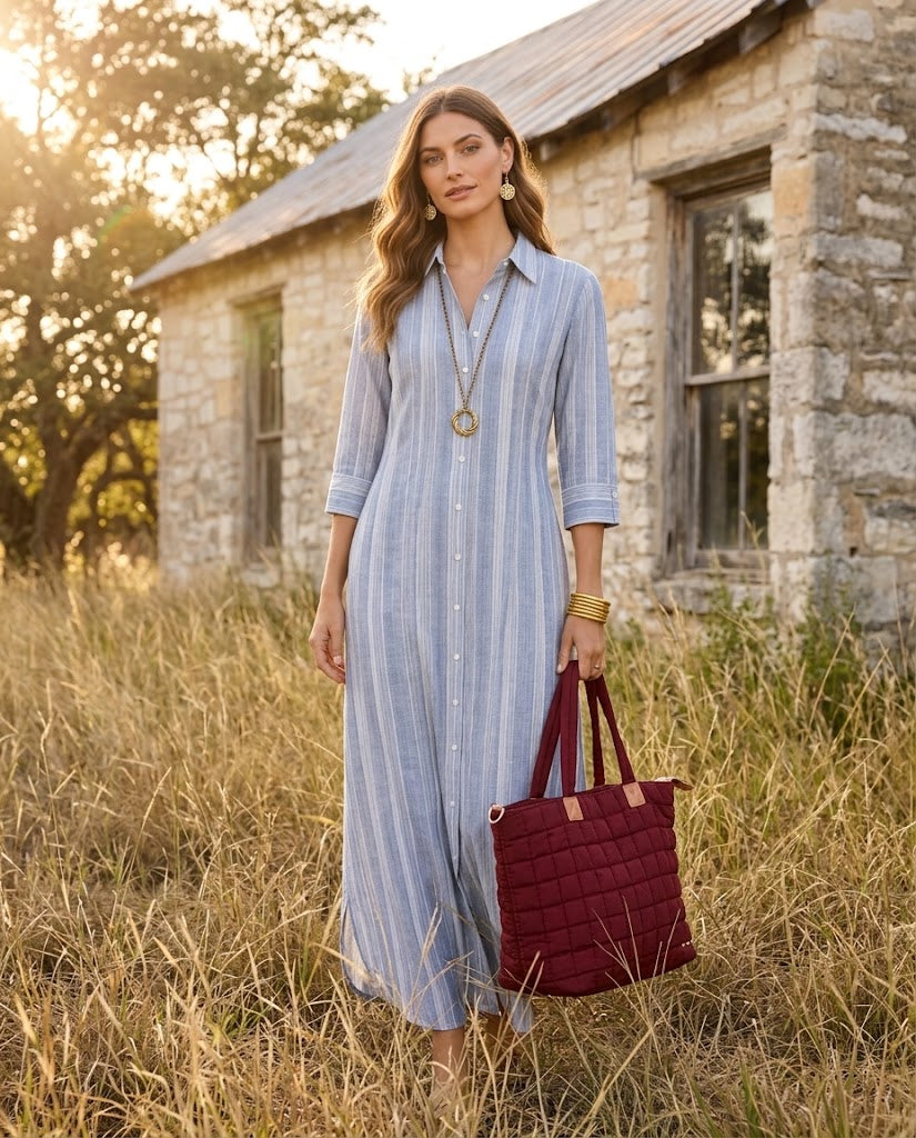 Chambray & Gold look — striped chambray button-front maxi styled with gold Ferrara earrings and long necklace, gold bangles, and a burgundy quilted tote