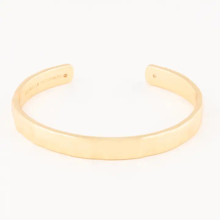 Gold bangle on a white background.Michelle McDowell Carolyn Cuff